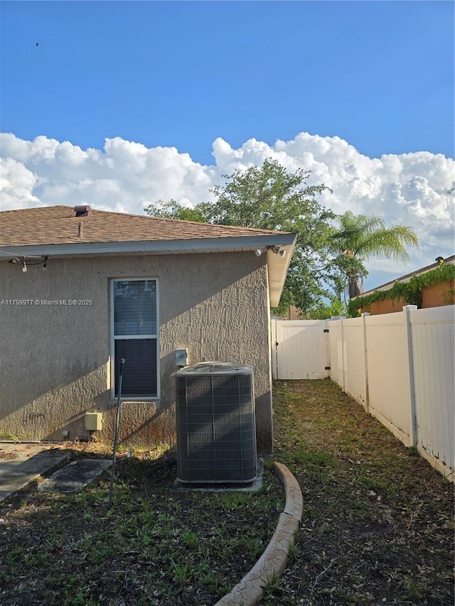 453 Dahoon Holly Dr, Daytona Beach, FL 32117 - view of side of home featuring cooling unit, a fenced backyard, and stucco siding