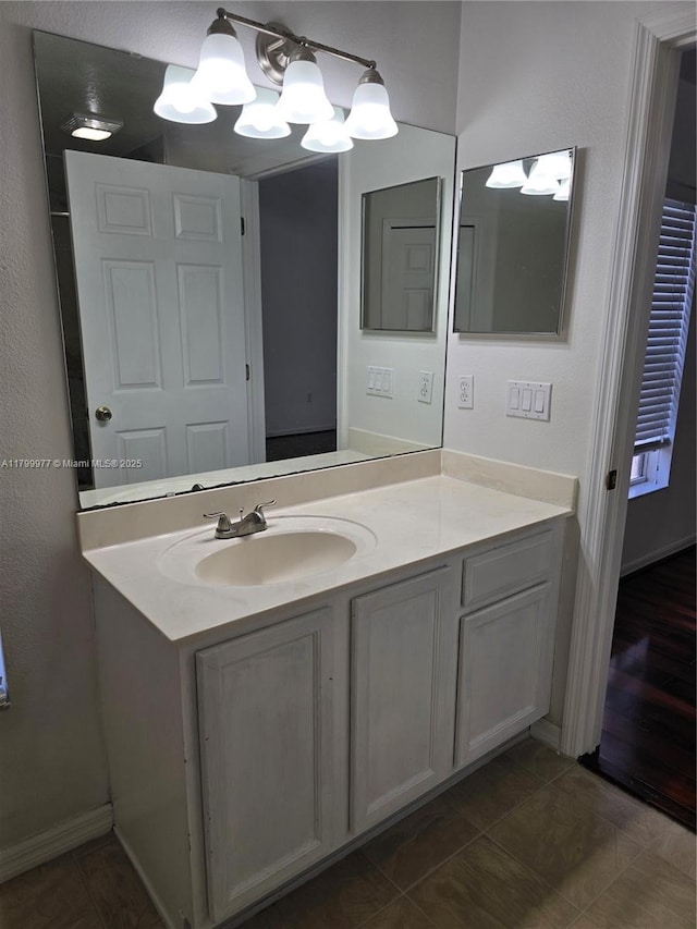 453 Dahoon Holly Dr, Daytona Beach, FL 32117 - bathroom with vanity, a chandelier, baseboards, and tile patterned floors