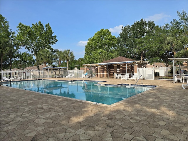 453 Dahoon Holly Dr, Daytona Beach, FL 32117 - community pool with fence and a patio