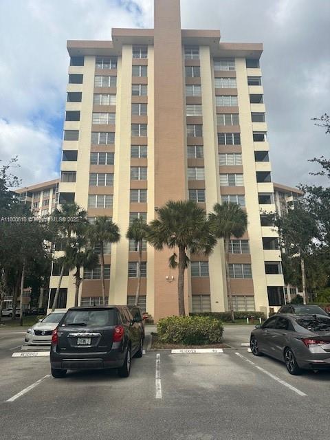 10777 W Sample Rd Unit 610, Coral Springs, FL 33065 - view of property featuring uncovered parking