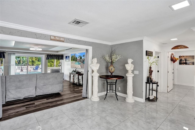 hall featuring ornamental molding, baseboards, and tile patterned floors