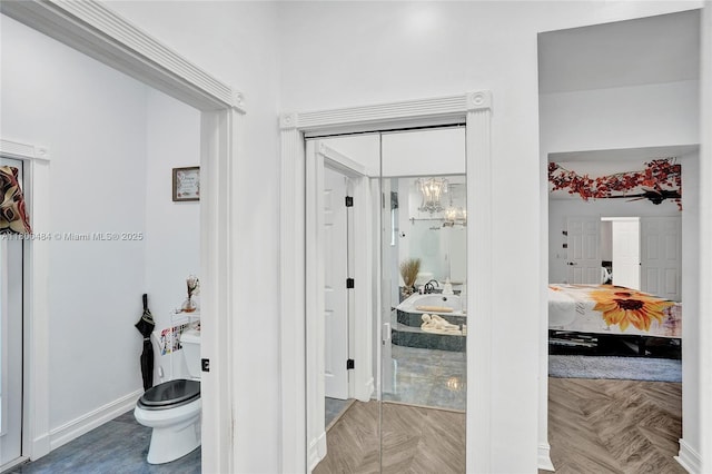 hallway featuring a chandelier