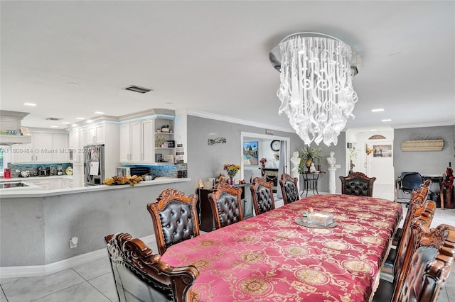 dining area featuring a chandelier, ornamental molding, light tile patterned flooring, and recessed lighting