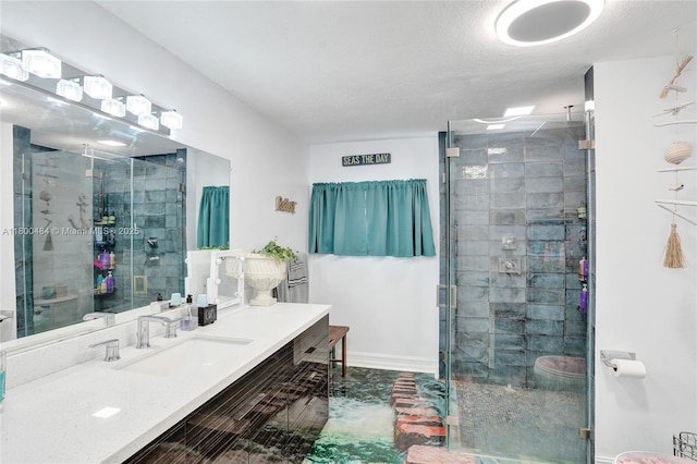 bathroom featuring a shower stall, vanity, and baseboards