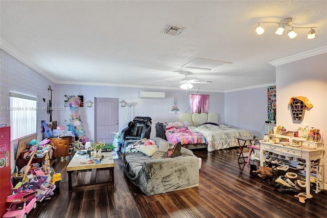 bedroom featuring an AC wall unit, attic access, ornamental molding, wood finished floors, and ceiling fan
