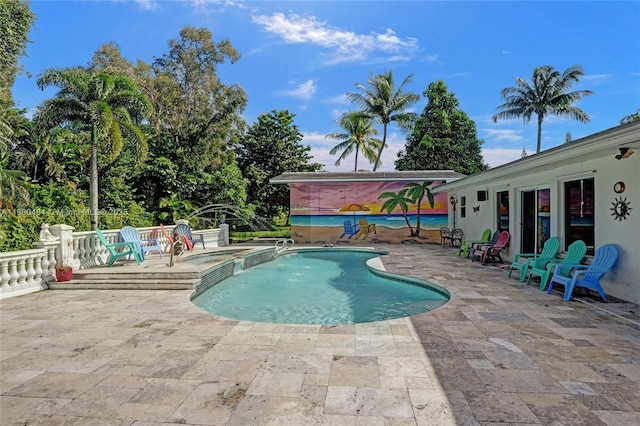 view of pool featuring a patio and a pool with connected hot tub