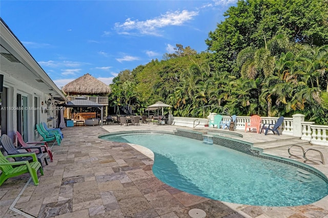 swimming pool featuring a gazebo, an in-ground hot tub, a patio, a fenced backyard, and an outdoor living space