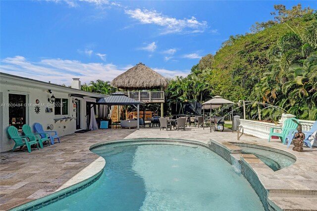 view of swimming pool with a gazebo, a patio area, and a pool with connected hot tub