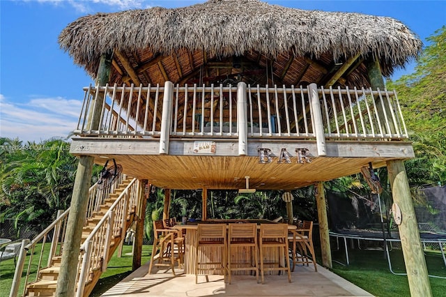 view of patio featuring a trampoline, stairway, and a gazebo