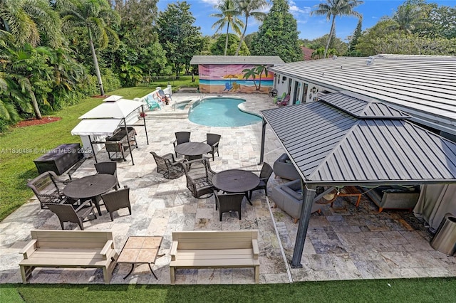 outdoor pool with a fenced backyard, a patio, and view of scattered trees