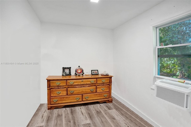 bedroom featuring wood finished floors and baseboards