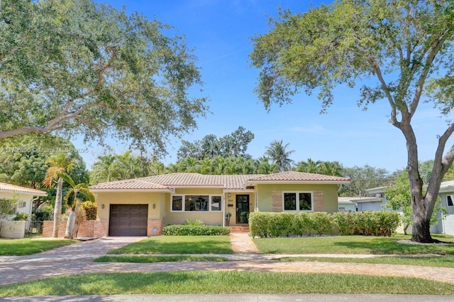 825 NE 98th St, Miami Shores, FL 33138 - single story home with a garage, a tile roof, driveway, and a front yard