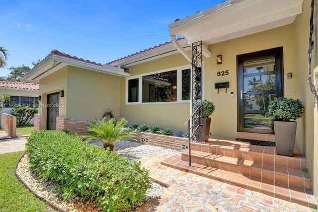 825 NE 98th St, Miami Shores, FL 33138 - entrance to property featuring stucco siding and a tiled roof