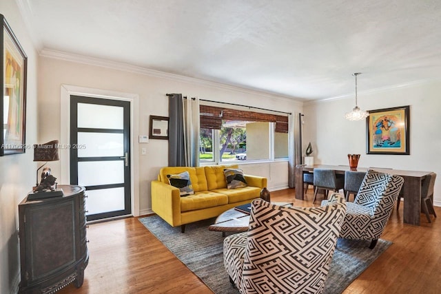 825 NE 98th St, Miami Shores, FL 33138 - living room featuring wood finished floors, ornamental molding, baseboards, and a chandelier