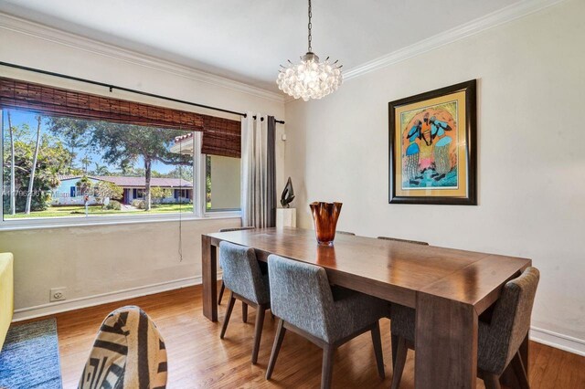 825 NE 98th St, Miami Shores, FL 33138 - dining space with a chandelier, baseboards, healthy amount of natural light, ornamental molding, and wood finished floors