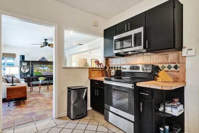 825 NE 98th St, Miami Shores, FL 33138 - kitchen featuring dark cabinetry, stainless steel appliances, and light countertops