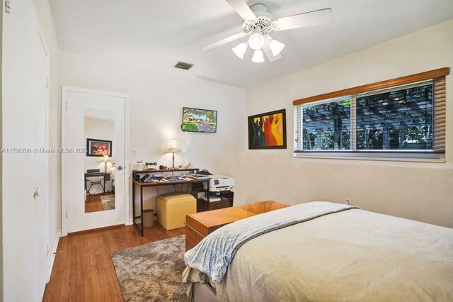 825 NE 98th St, Miami Shores, FL 33138 - bedroom with wood finished floors and a ceiling fan