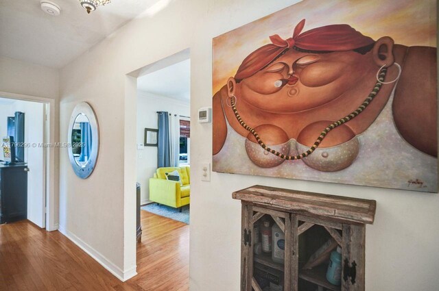 825 NE 98th St, Miami Shores, FL 33138 - corridor with wood finished floors, baseboards, and ornamental molding