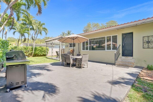 825 NE 98th St, Miami Shores, FL 33138 - view of patio with entry steps, fence, outdoor dining space, and area for grilling