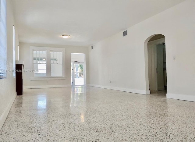 1436 SW 3rd St, Miami, FL 33135 - spare room with arched walkways and speckle patterned floor
