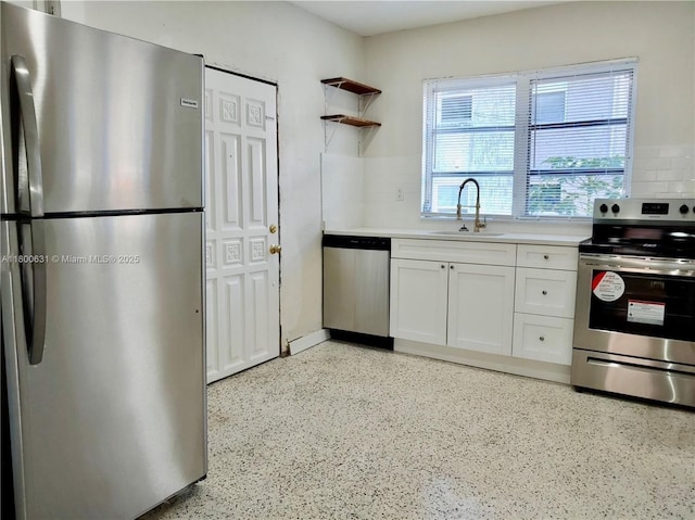 1436 SW 3rd St, Miami, FL 33135 - kitchen featuring stainless steel appliances, white cabinets, light countertops, tasteful backsplash, and dark aggregate flooring