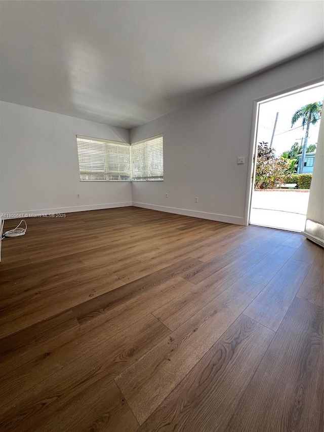1605 Lenox Ave Unit 1605-9, Miami Beach, FL 33139 - unfurnished room featuring baseboards and dark wood finished floors