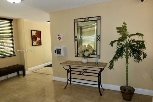 3801 Environ Blvd Unit 516, Lauderhill, FL 33319 - corridor with baseboards and a textured ceiling