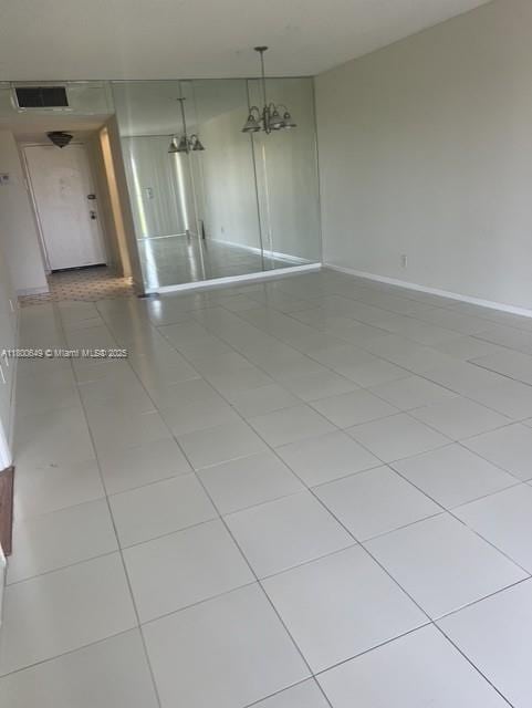 3801 Environ Blvd Unit 516, Lauderhill, FL 33319 - empty room featuring a chandelier, tile patterned flooring, and baseboards