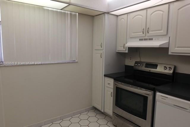 3801 Environ Blvd Unit 516, Lauderhill, FL 33319 - kitchen with under cabinet range hood, stainless steel electric stove, dishwasher, dark countertops, and white cabinets