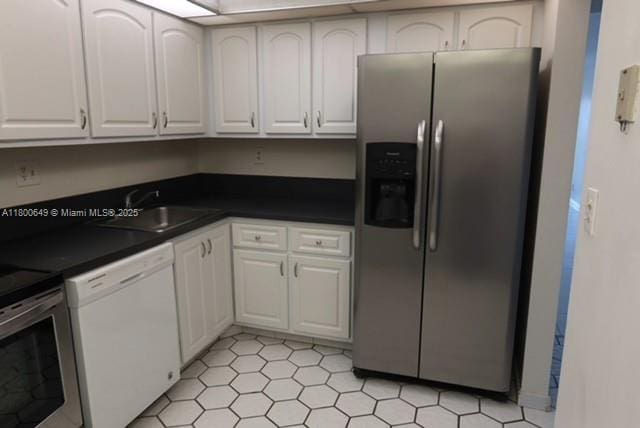 3801 Environ Blvd Unit 516, Lauderhill, FL 33319 - kitchen with appliances with stainless steel finishes, a sink, dark countertops, and white cabinets
