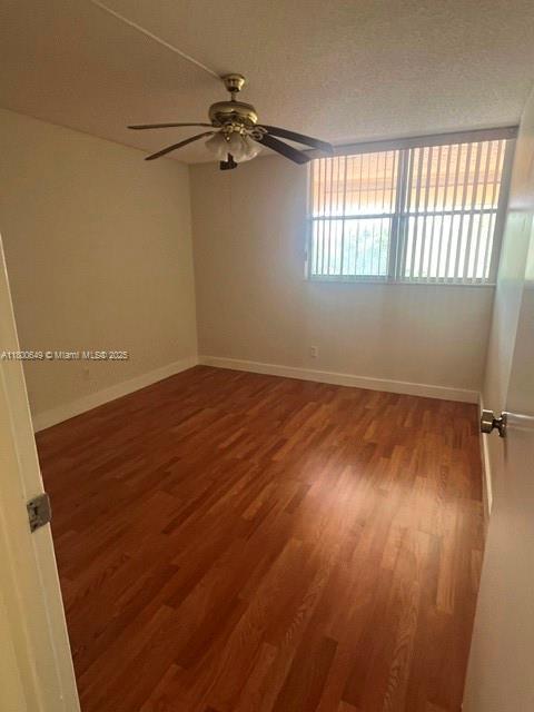 3801 Environ Blvd Unit 516, Lauderhill, FL 33319 - spare room with wood finished floors, baseboards, and a ceiling fan