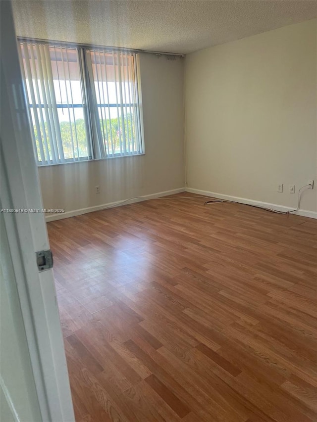 3801 Environ Blvd Unit 516, Lauderhill, FL 33319 - spare room featuring wood finished floors, baseboards, and a textured ceiling