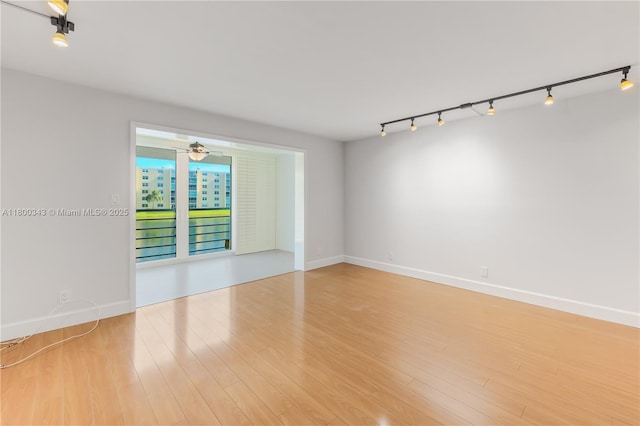 431 SE 3rd St Unit 201, Dania Beach, FL 33004 - unfurnished room featuring track lighting, wood finished floors, ceiling fan, and baseboards