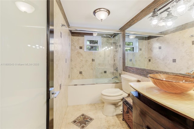 431 SE 3rd St Unit 201, Dania Beach, FL 33004 - full bath featuring toilet, vanity, shower / bath combination with glass door, tile patterned flooring, and tile walls