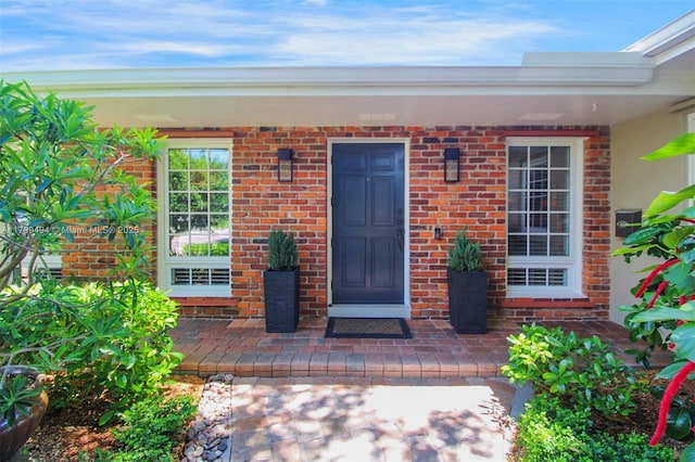 8345 SW 143rd St, Palmetto Bay, FL 33158 - doorway to property with brick siding and a porch
