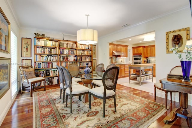 8345 SW 143rd St, Palmetto Bay, FL 33158 - dining space featuring crown molding and light wood-style floors