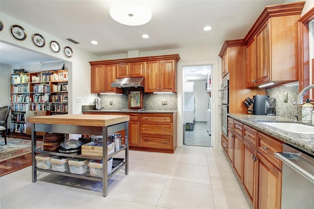 8345 SW 143rd St, Palmetto Bay, FL 33158 - kitchen with appliances with stainless steel finishes, under cabinet range hood, light stone counters, decorative backsplash, and recessed lighting