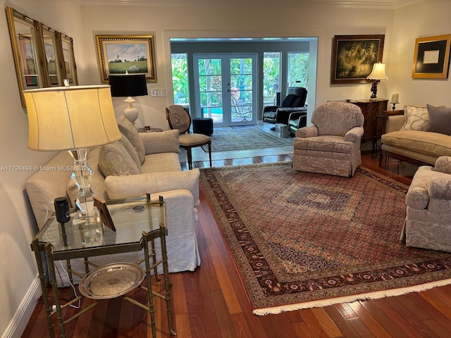 living area featuring french doors, hardwood / wood-style floors, ornamental molding, and baseboards