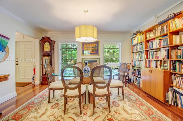 8345 SW 143rd St, Palmetto Bay, FL 33158 - dining space featuring plenty of natural light, wood finished floors, crown molding, and a fireplace