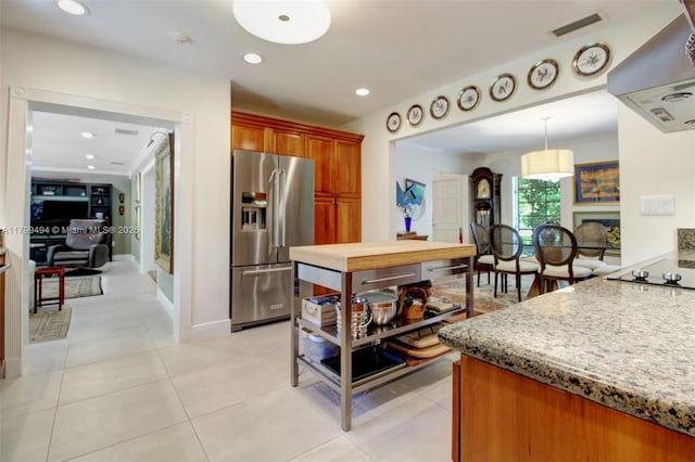 8345 SW 143rd St, Palmetto Bay, FL 33158 - kitchen featuring high end fridge, exhaust hood, brown cabinetry, light stone countertops, and black electric stovetop