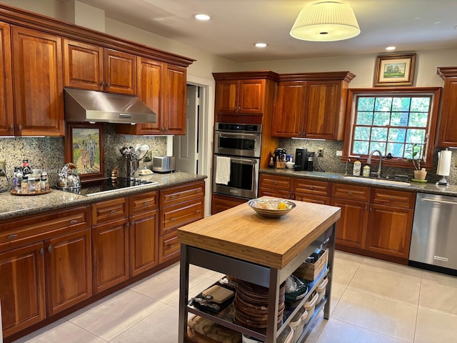 kitchen featuring a sink, under cabinet range hood, appliances with stainless steel finishes, light tile patterned floors, and recessed lighting