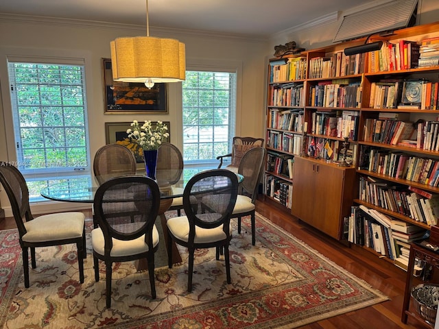 dining room featuring wood finished floors and ornamental molding