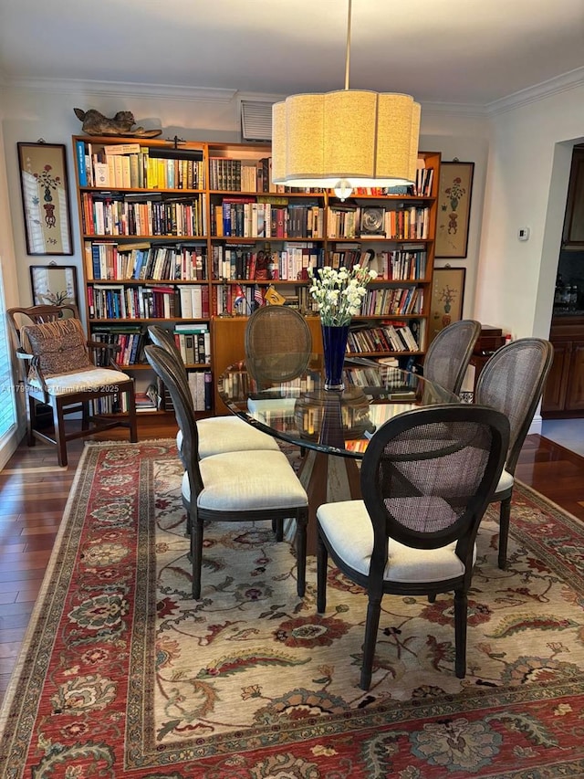 sitting room with crown molding and wood finished floors