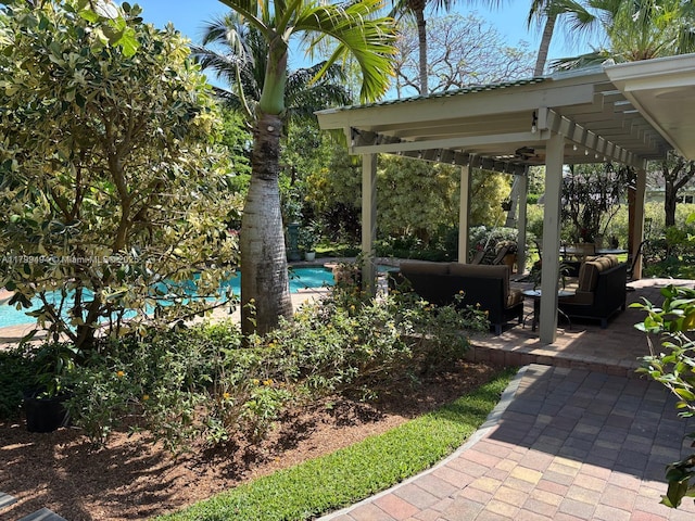 view of yard with outdoor lounge area, an outdoor pool, and a patio