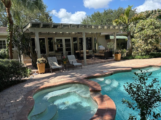 view of swimming pool featuring a patio, french doors, and a pool with connected hot tub