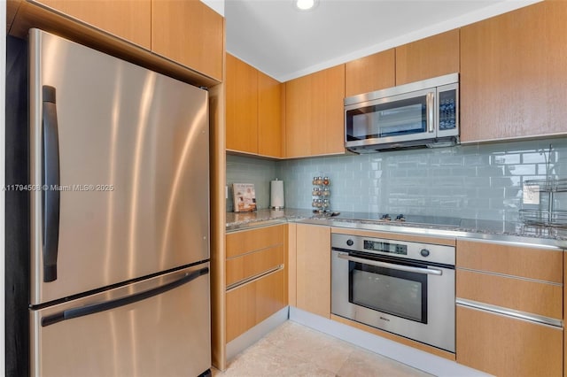 kitchen featuring stainless steel appliances, light stone countertops, decorative backsplash, recessed lighting, and light tile patterned floors