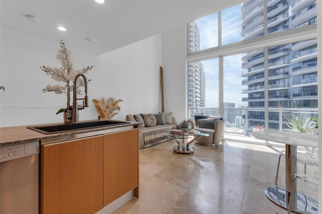 living area with a wall of windows, a city view, and recessed lighting
