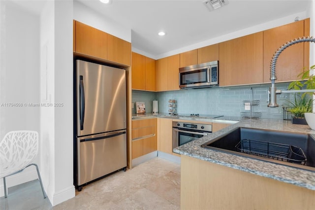1050 Brickell Ave Unit 2416, Miami, FL 33131 - kitchen featuring stainless steel appliances, a sink, light stone counters, tasteful backsplash, and recessed lighting