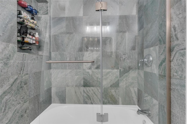 full bath featuring combined bath / shower with glass door
