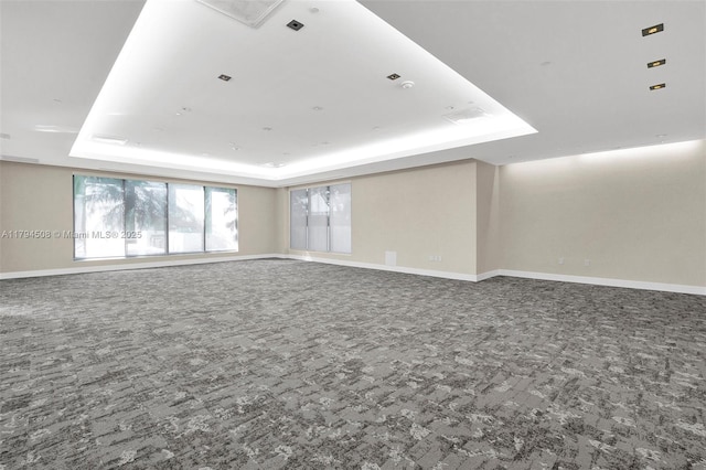 1050 Brickell Ave Unit 2416, Miami, FL 33131 - empty room with a tray ceiling, baseboards, and carpet